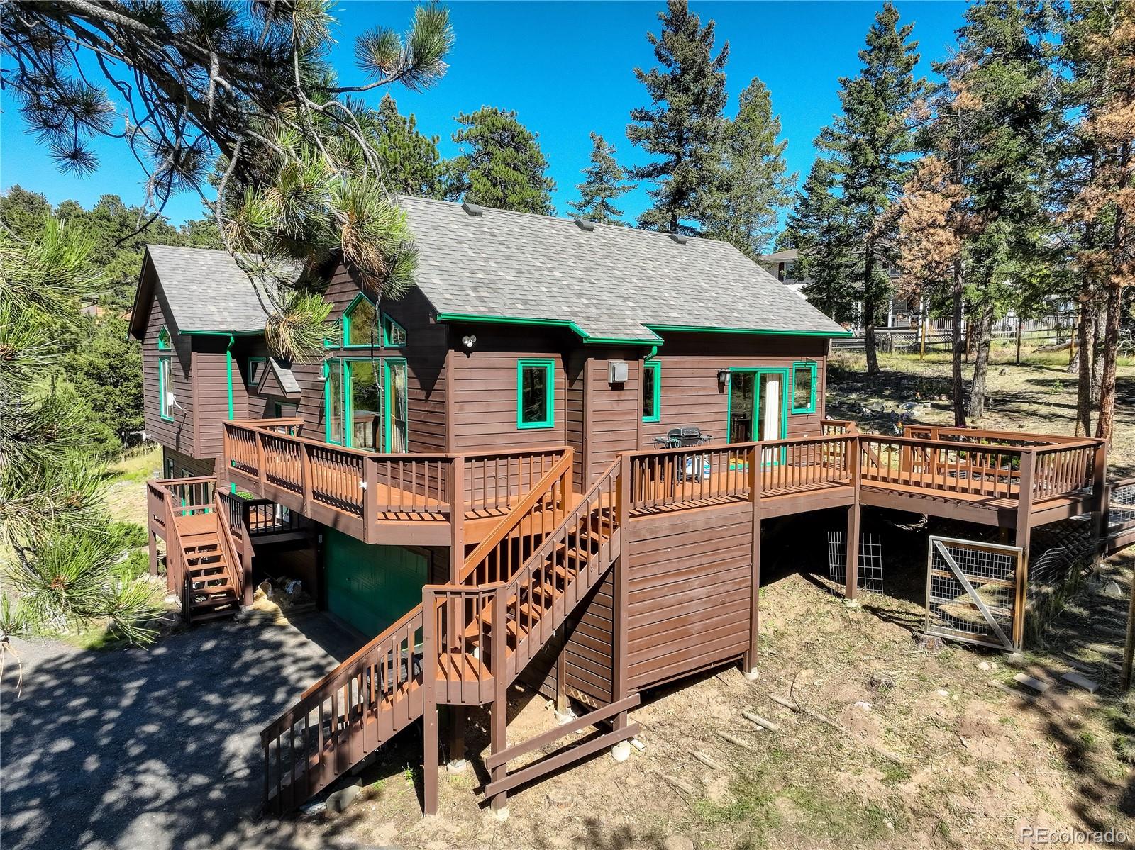 9758 Fallen Rock Road Conifer, CO 80433 - Photo 31 of 42 a balcony with furniture and a potted plant