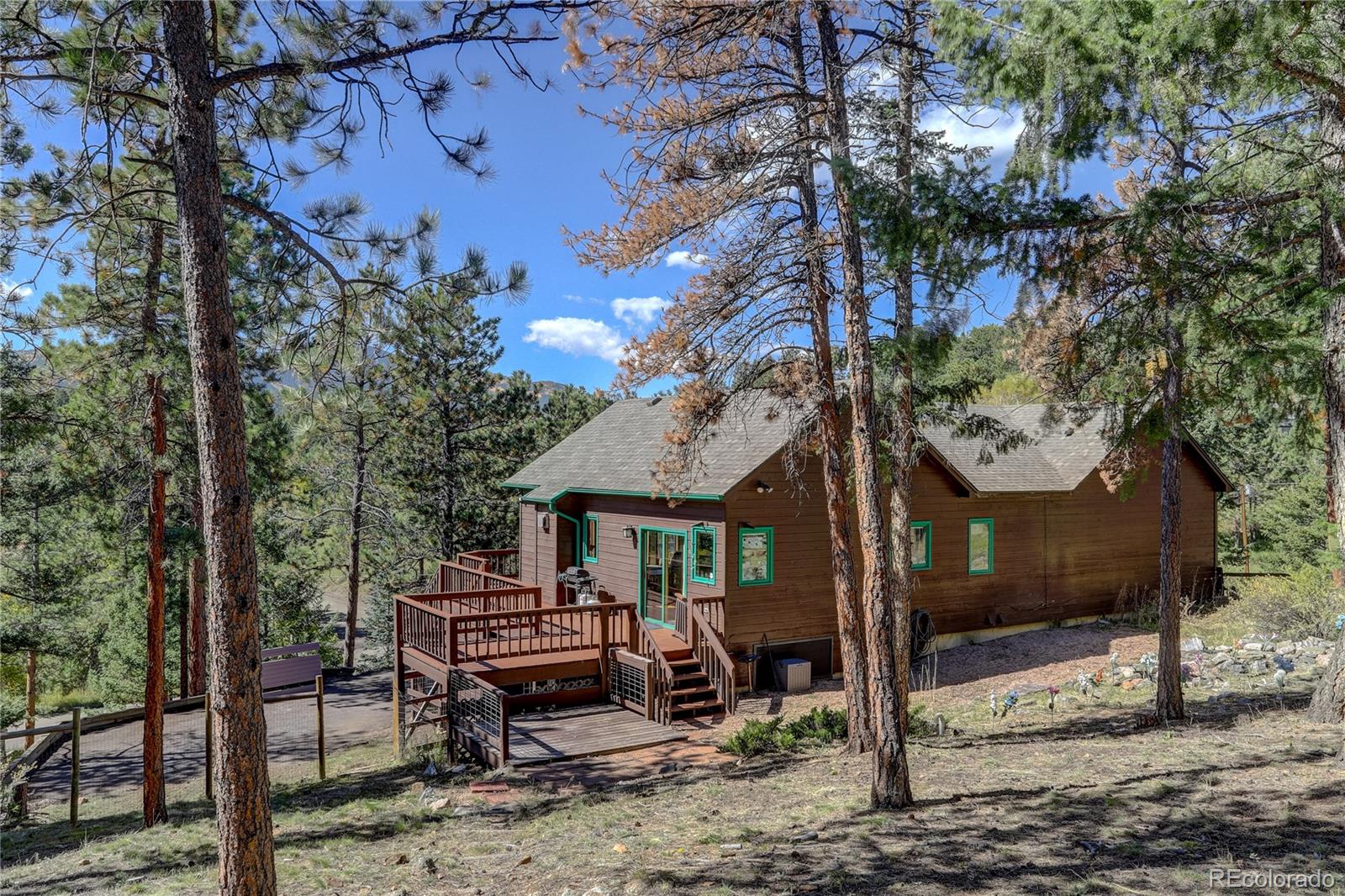 9758 Fallen Rock Road Conifer, CO 80433 - Photo 35 of 42 a front view of a house with garden