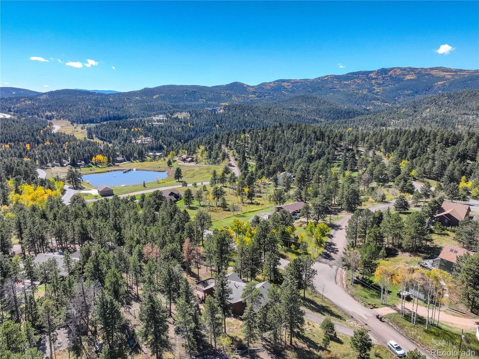 9758 Fallen Rock Road Conifer, CO 80433 - Photo 38 of 42 a view of a city with mountains in the background