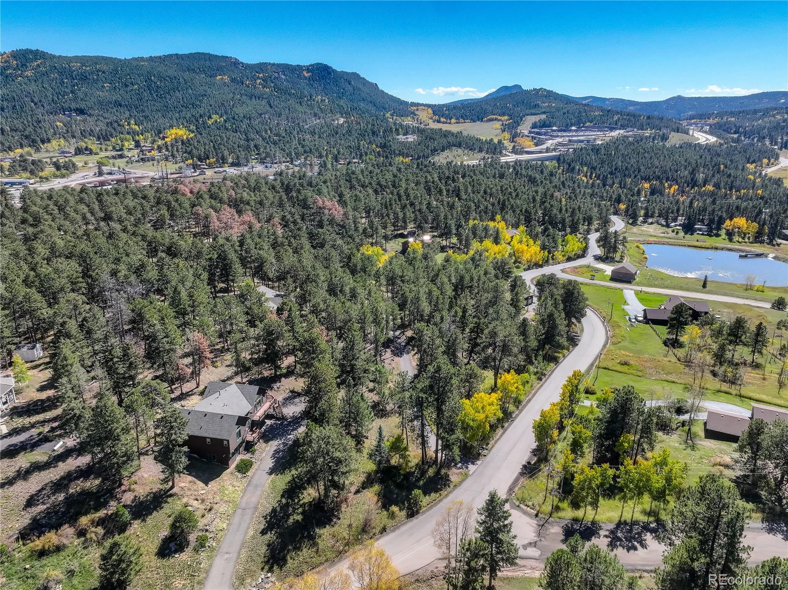 9758 Fallen Rock Road Conifer, CO 80433 - Photo 39 of 42 a view of a city with mountains in the background