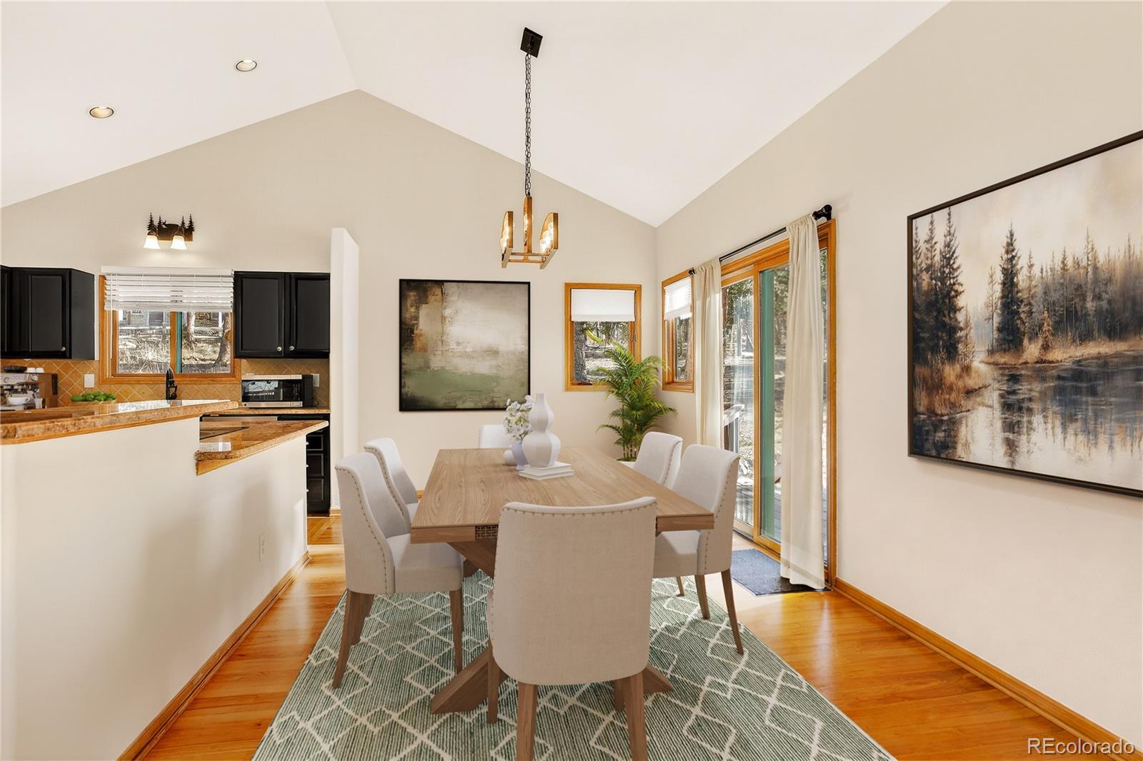9758 Fallen Rock Road Conifer, CO 80433 - Photo 7 of 42 a view of a dining room with furniture window and wooden floor