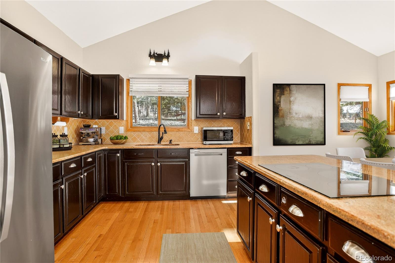 9758 Fallen Rock Road Conifer, CO 80433 - Photo 9 of 42 a kitchen with stainless steel appliances granite countertop a sink stove and refrigerator