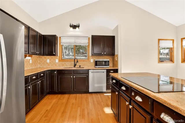 a kitchen with a sink appliances and cabinets