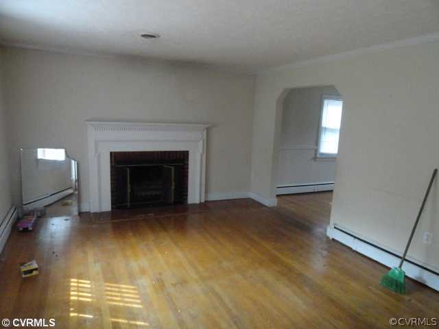 8312 Lansdowne Road Richmond, VA 23229 - Photo 2 of 6 a view of empty room with wooden floor and fireplace