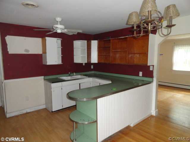 8312 Lansdowne Road Richmond, VA 23229 - Photo 3 of 6 a bathroom with a sink a mirror and a bathtub