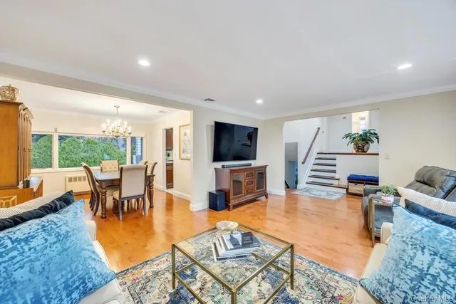 a living room with furniture a flat screen tv and a large window