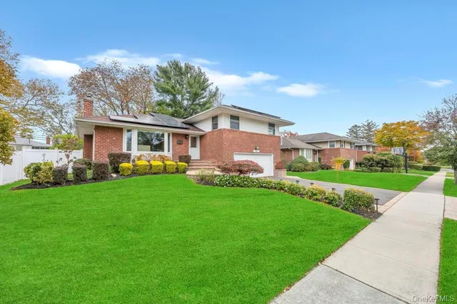 a front view of house with yard and green space