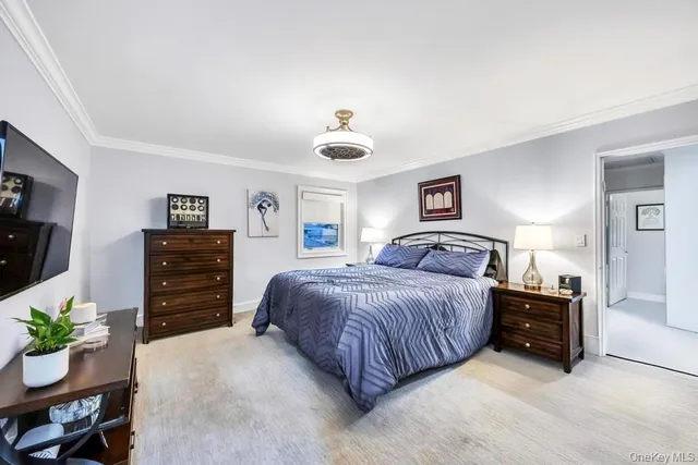 a bedroom with a bed and dresser with chair