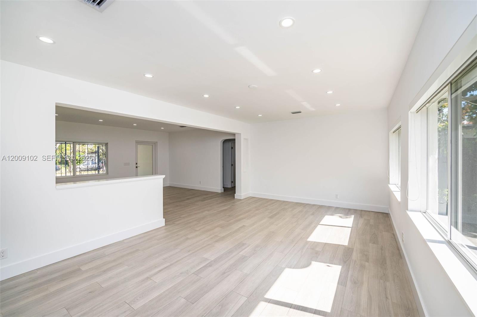 330 Southwest 27th Road Miami, FL 33129 - Photo 10 of 62 an empty room with wooden floor and windows