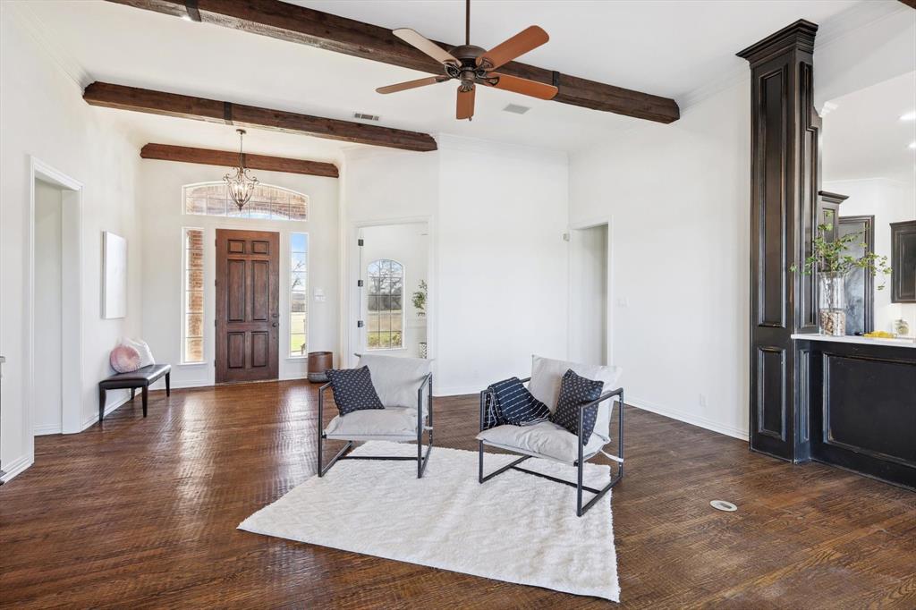 12886 St John Road Pilot Point, TX 76258 - Photo 12 of 35 Foyer entrance featuring beam ceiling, dark wood finished floors, a ceiling fan, a chandelier, and baseboards