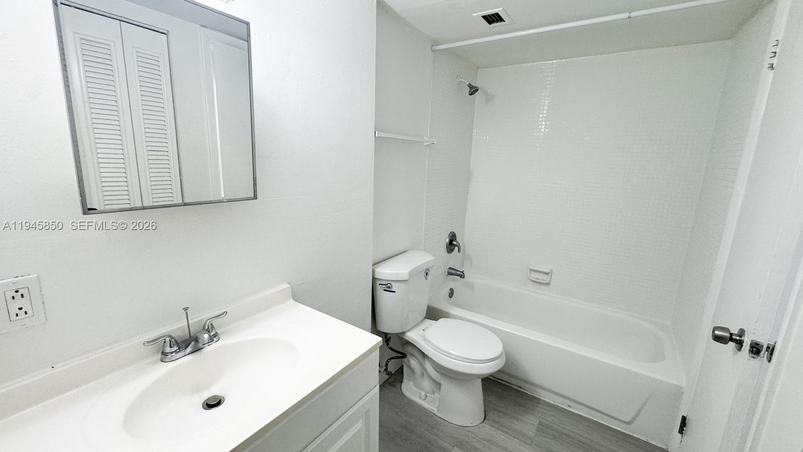 484 Northwest 165th St Road, Unit A314 Miami, FL 33169 - Photo 13 of 35 a bathroom with a sink a toilet and shower