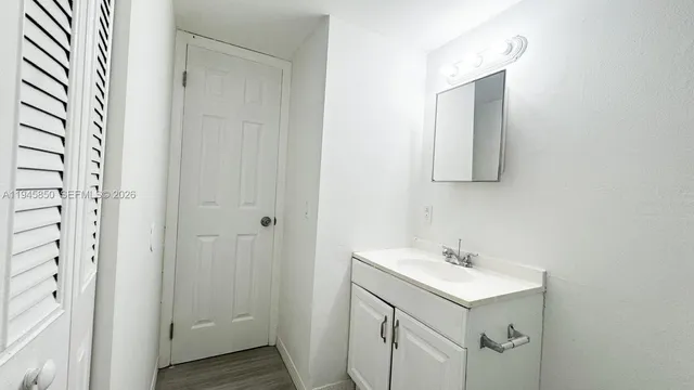a bathroom with a sink mirror and vanity