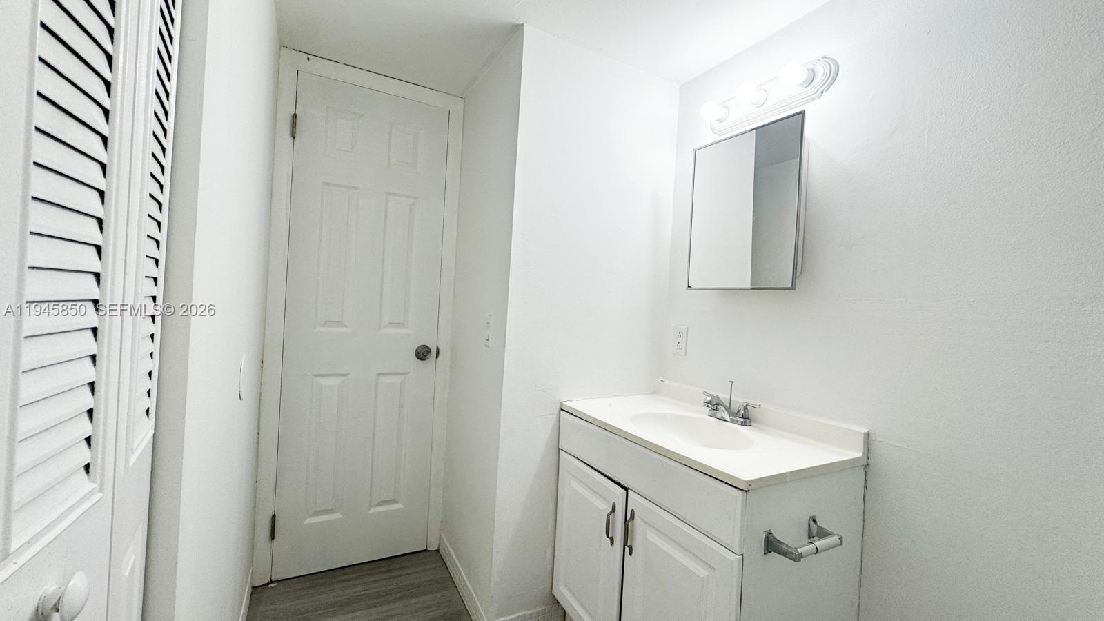 484 Northwest 165th St Road, Unit A314 Miami, FL 33169 - Photo 14 of 35 a bathroom with a sink mirror and vanity