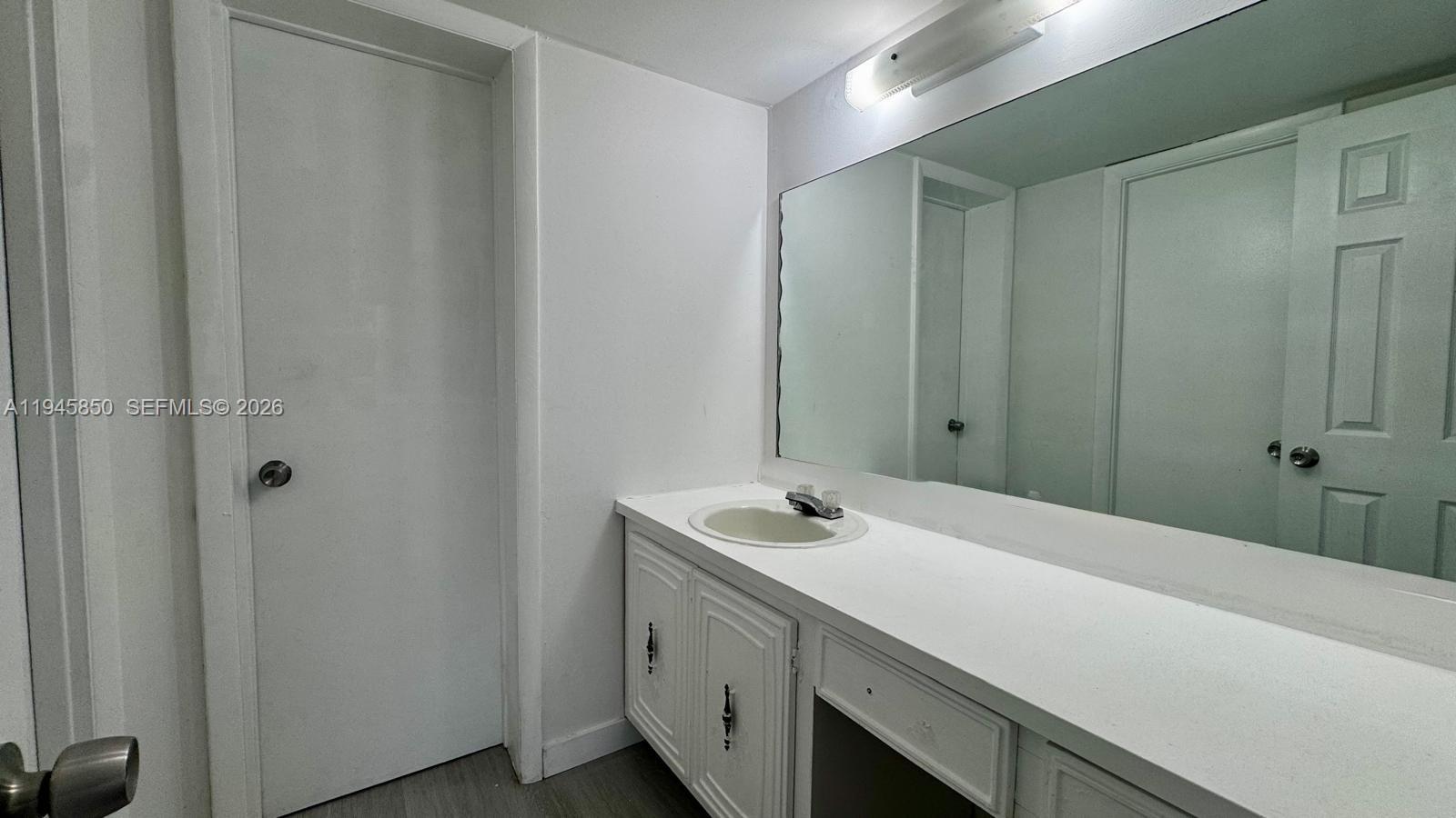 484 Northwest 165th St Road, Unit A314 Miami, FL 33169 - Photo 20 of 35 a bathroom with a sink and a large mirror