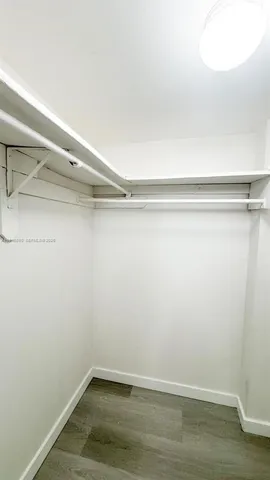 a balcony with wooden floor and city view