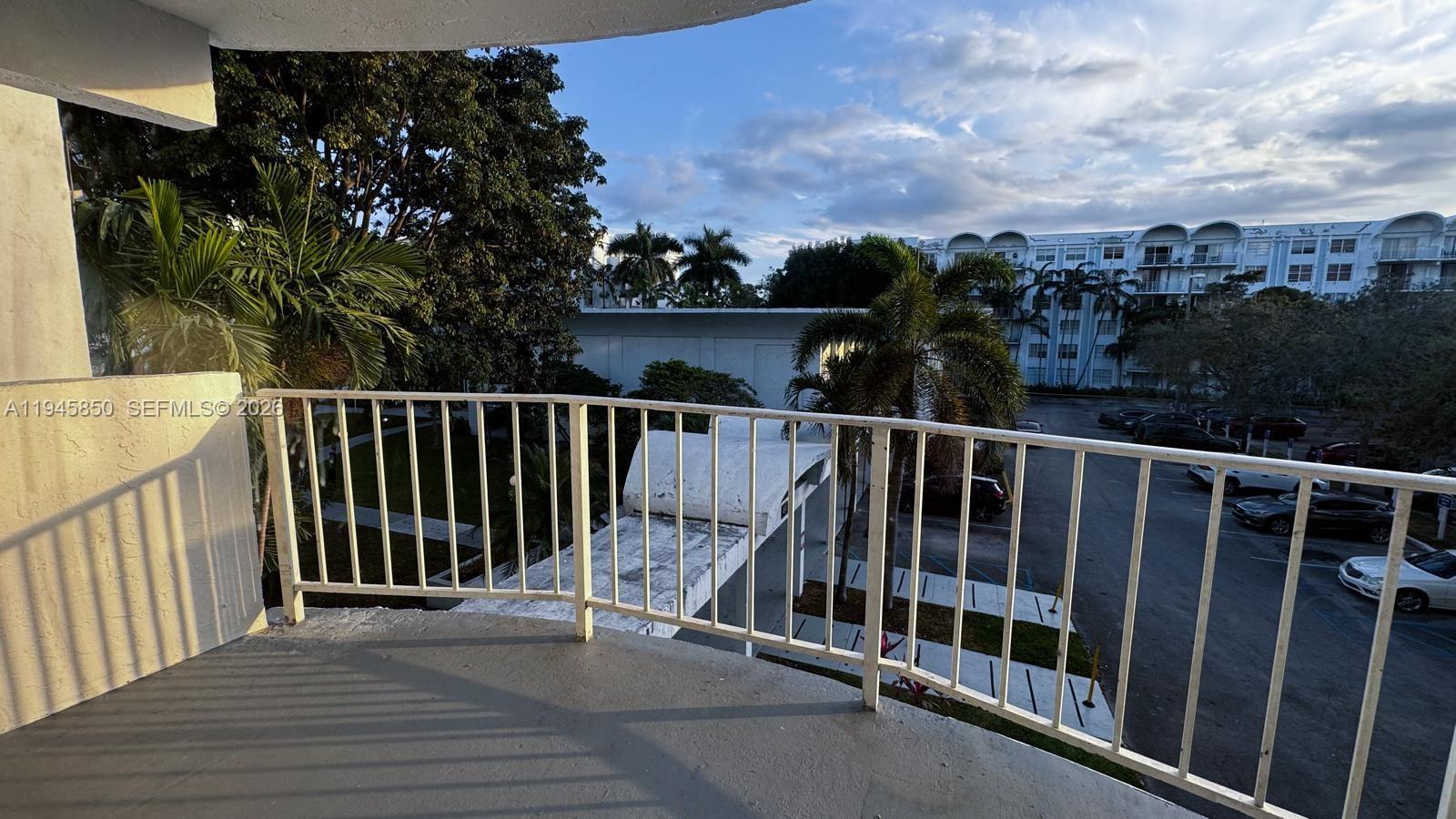 484 Northwest 165th St Road, Unit A314 Miami, FL 33169 - Photo 24 of 35 a balcony with wooden floor and city view