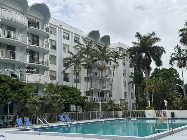 a swimming pool with outdoor seating and yard