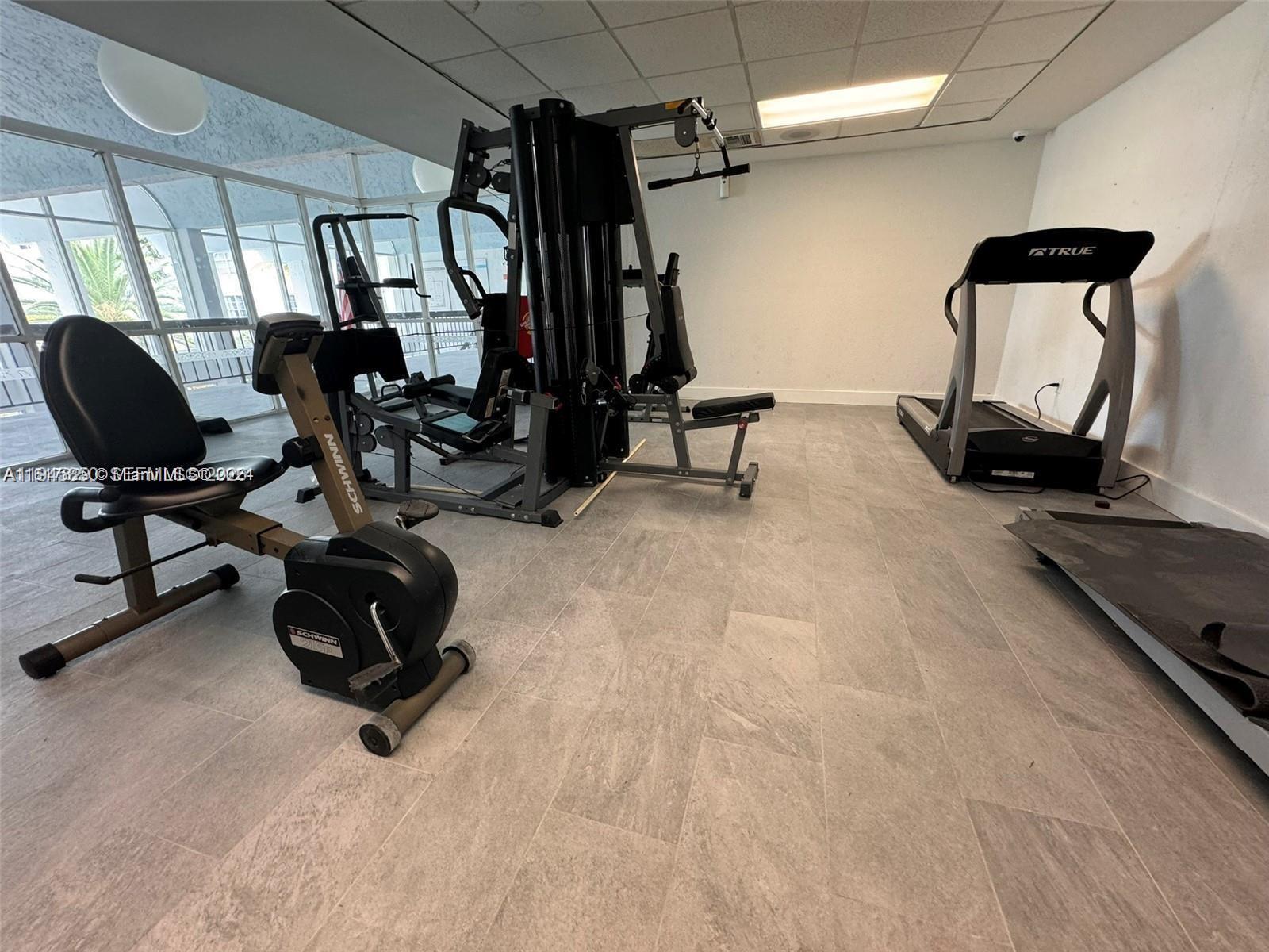 484 Northwest 165th St Road, Unit A314 Miami, FL 33169 - Photo 30 of 35 a view of a room with gym equipment