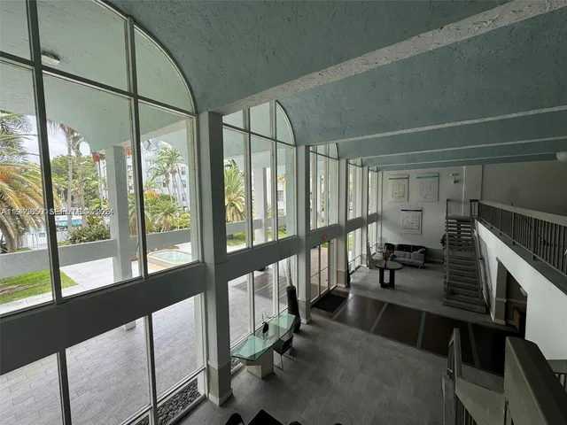 a view of hall with dining room and floor to ceiling window or lake