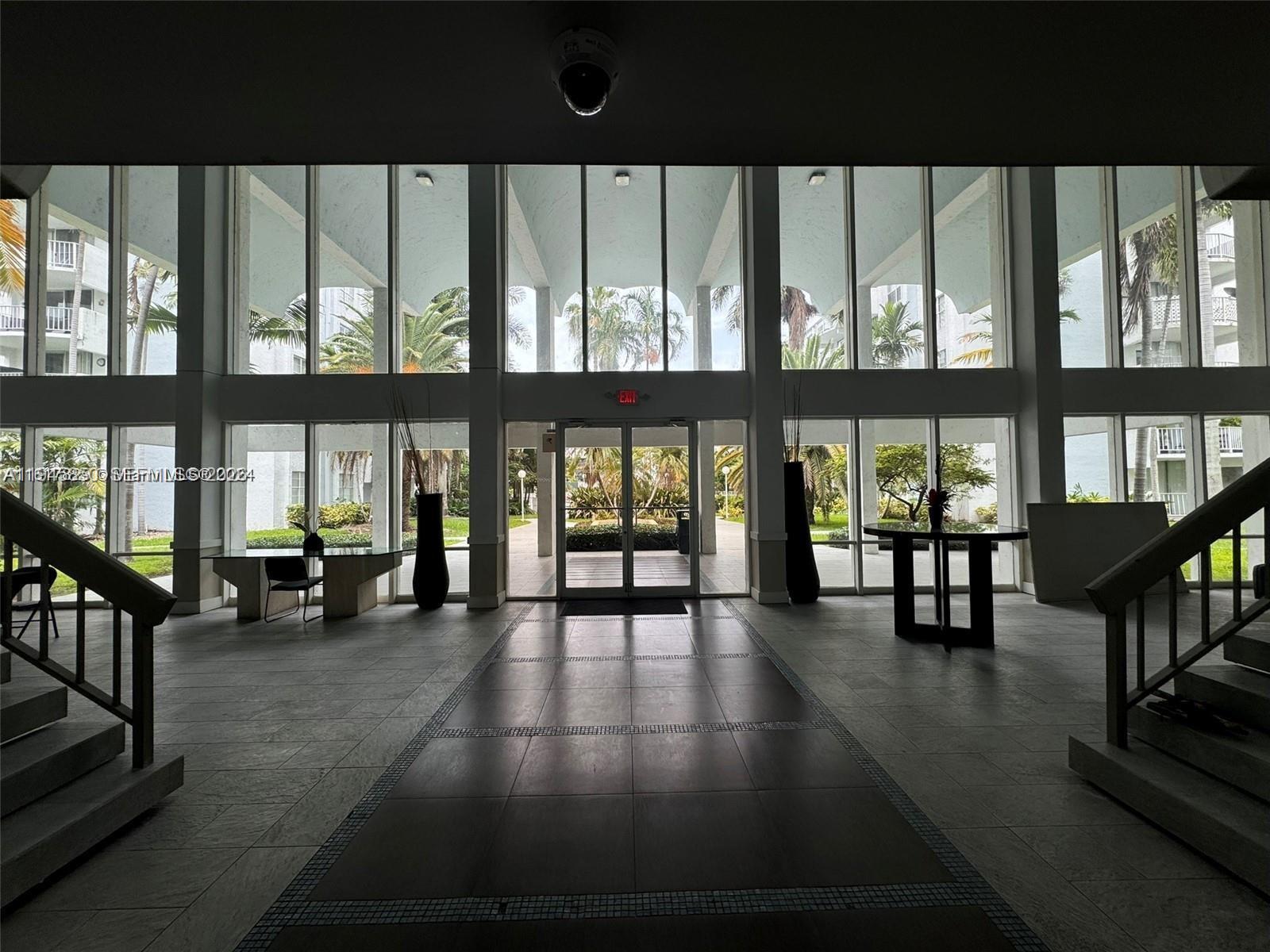 484 Northwest 165th St Road, Unit A314 Miami, FL 33169 - Photo 33 of 35 a view of hall with dining room and floor to ceiling window or lake