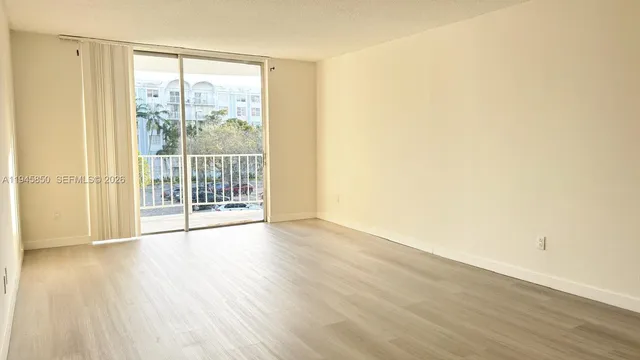 a view of wooden floor and windows in a room