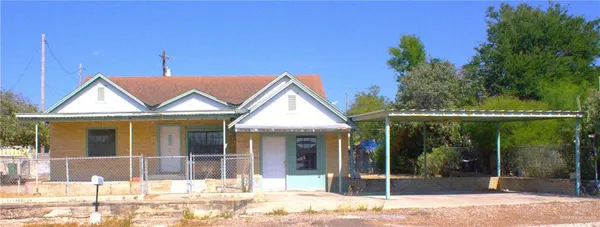 a view of a house with a porch and a garden