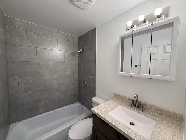 a bathroom with a sink a toilet and bathtub