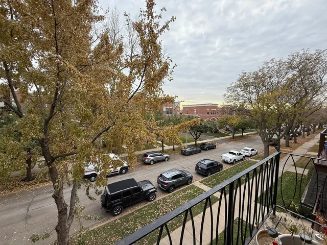 a view of a balcony with chairs and wooden floor