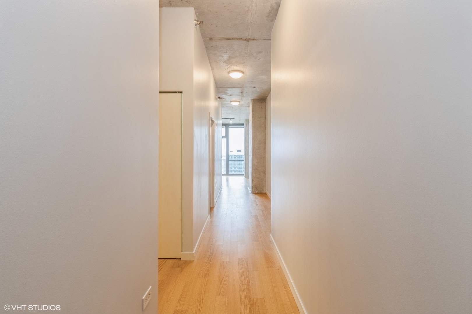 235 West Van Buren Street, Unit 4209 Chicago, IL 60607 - Photo 2 of 10 a view of a hallway with wooden floor