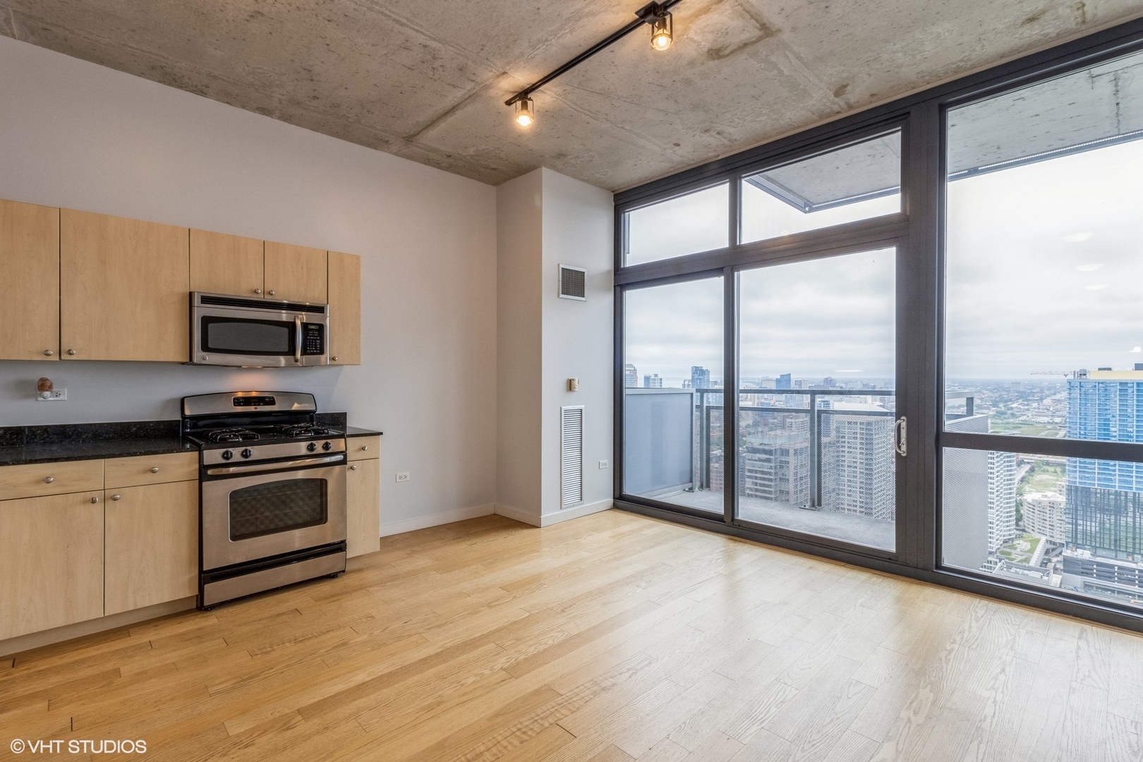 235 West Van Buren Street, Unit 4209 Chicago, IL 60607 - Photo 4 of 10 a view of a kitchen with a sink and microwave