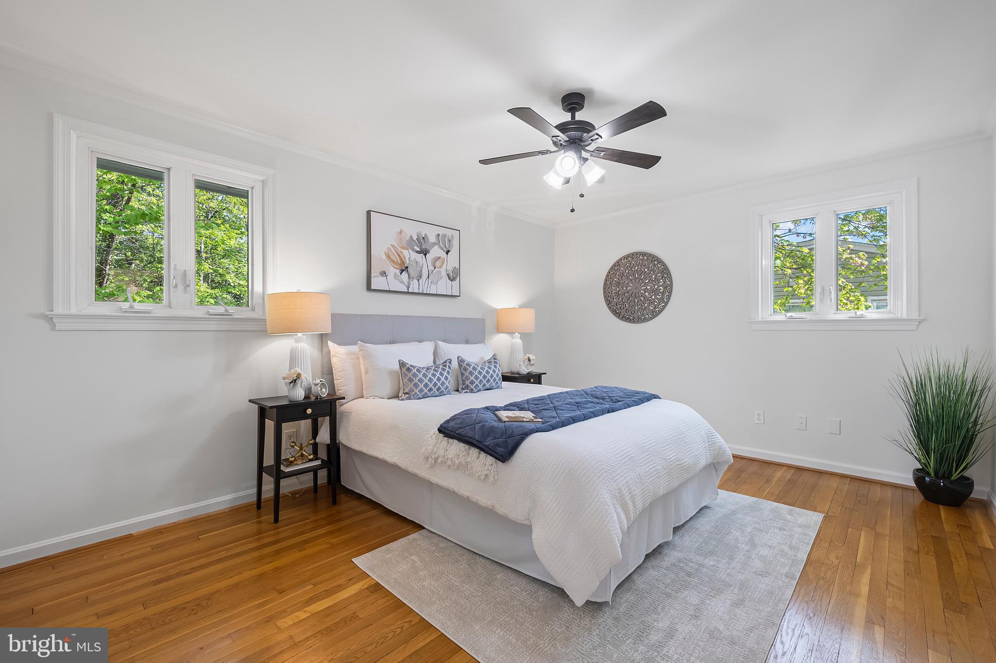 9821 Singleton Drive Bethesda, MD 20817 - Photo 14 of 45 a bedroom with a bed chandelier and a window