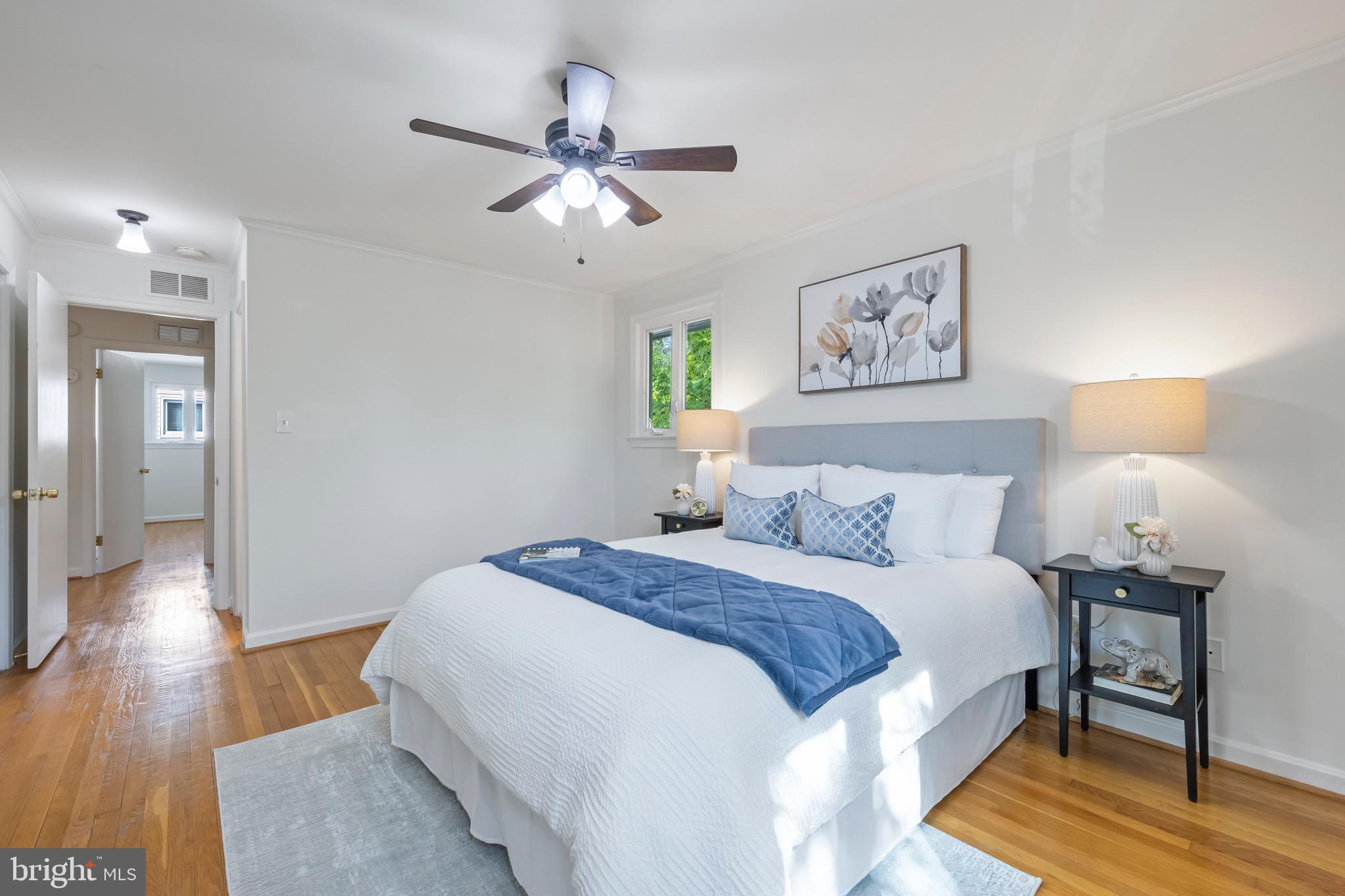 9821 Singleton Drive Bethesda, MD 20817 - Photo 15 of 45 a bedroom with a bed and wooden floor