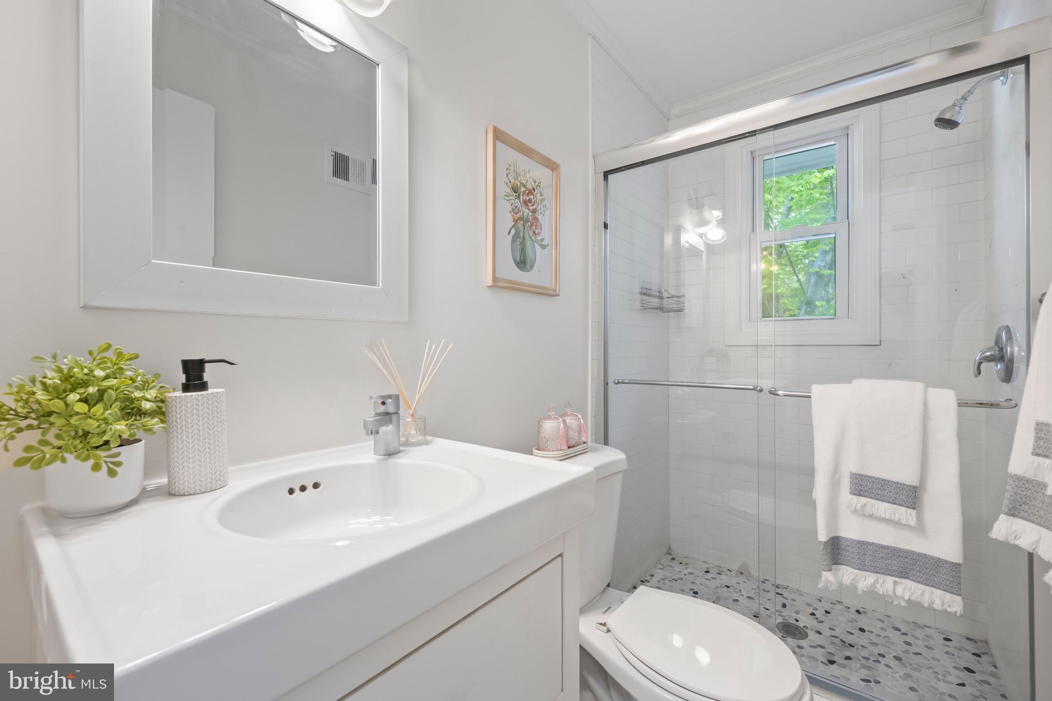 9821 Singleton Drive Bethesda, MD 20817 - Photo 16 of 45 a bathroom with a sink mirror vanity and toilet