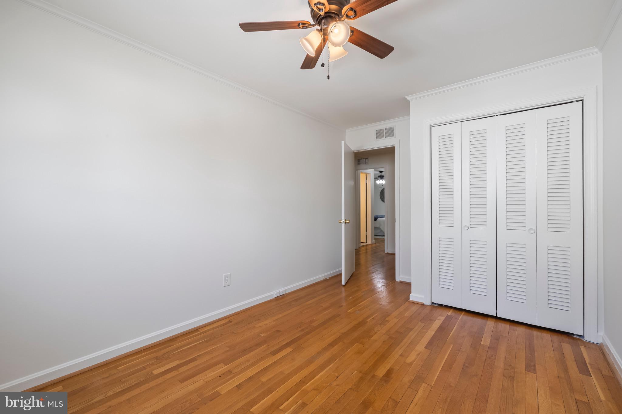 9821 Singleton Drive Bethesda, MD 20817 - Photo 18 of 45 a view of a room with wooden floor and white walls