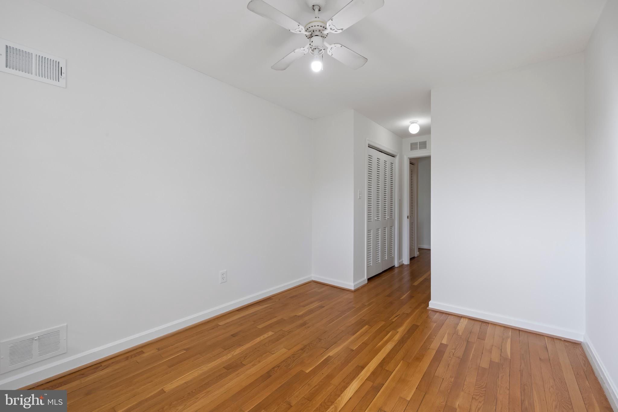 9821 Singleton Drive Bethesda, MD 20817 - Photo 22 of 45 a view of an empty room with wooden floor