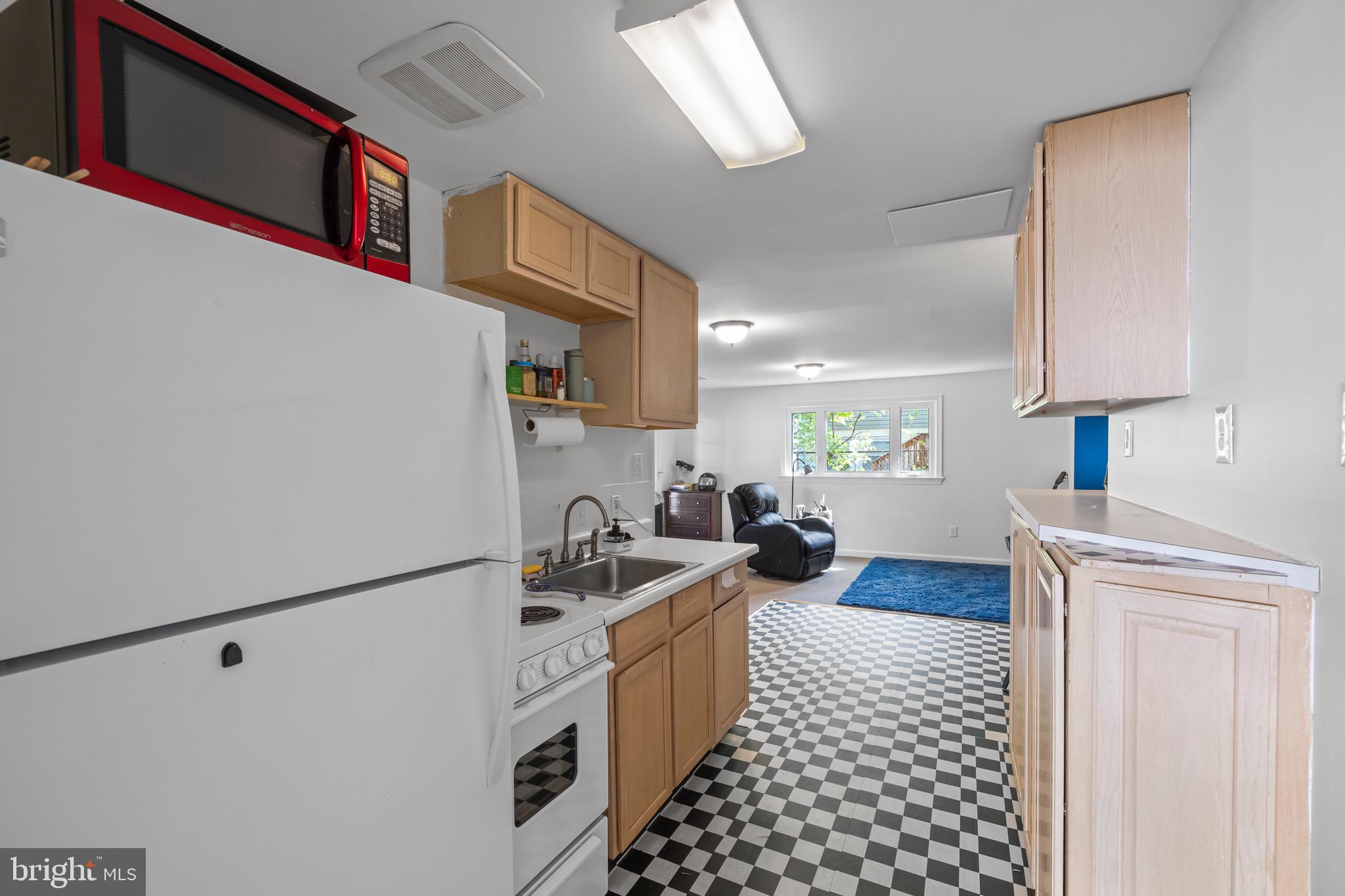 9821 Singleton Drive Bethesda, MD 20817 - Photo 25 of 45 a kitchen with a sink a stove and a refrigerator