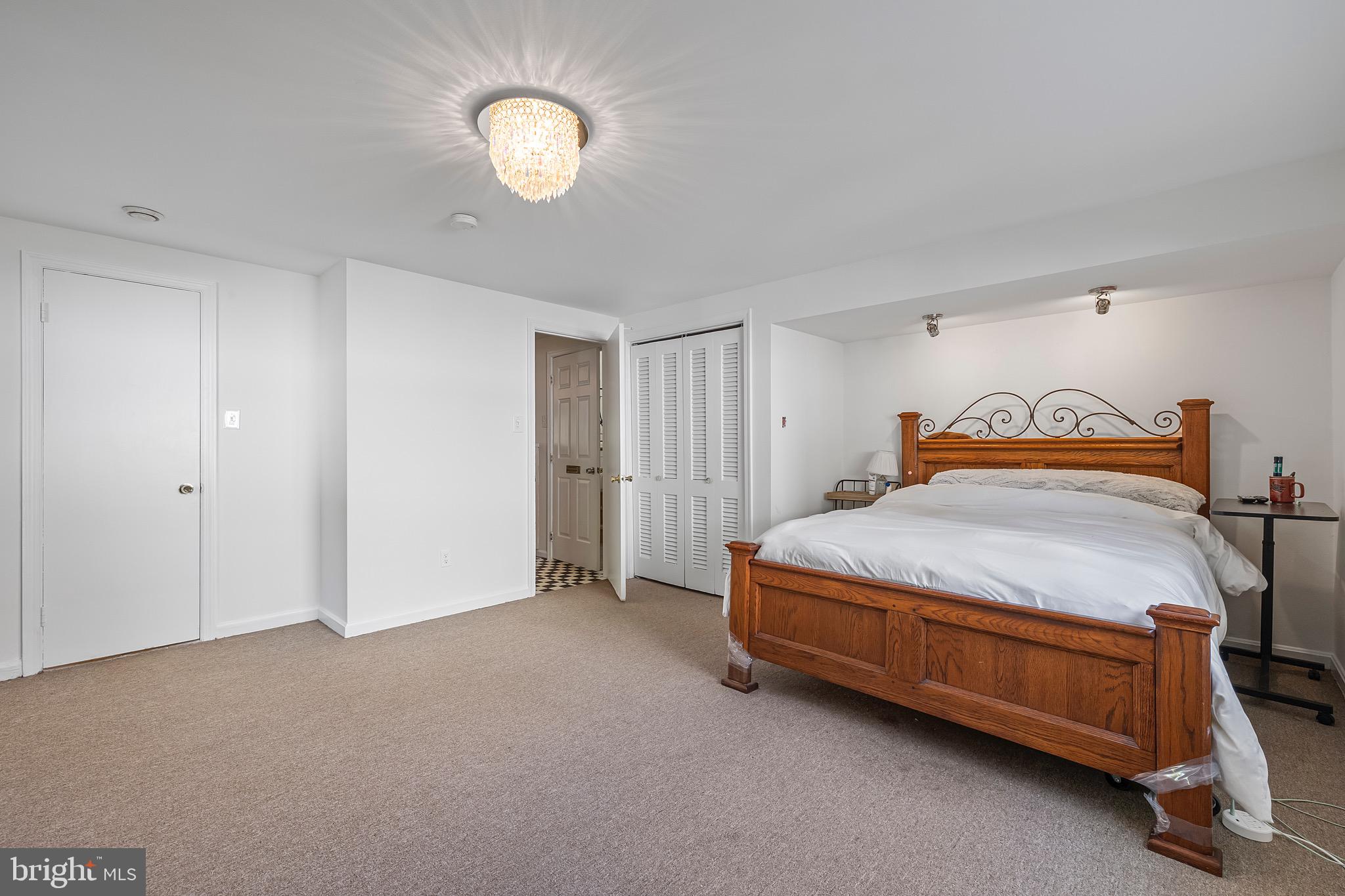 9821 Singleton Drive Bethesda, MD 20817 - Photo 30 of 45 a bedroom with a bed and a lamp