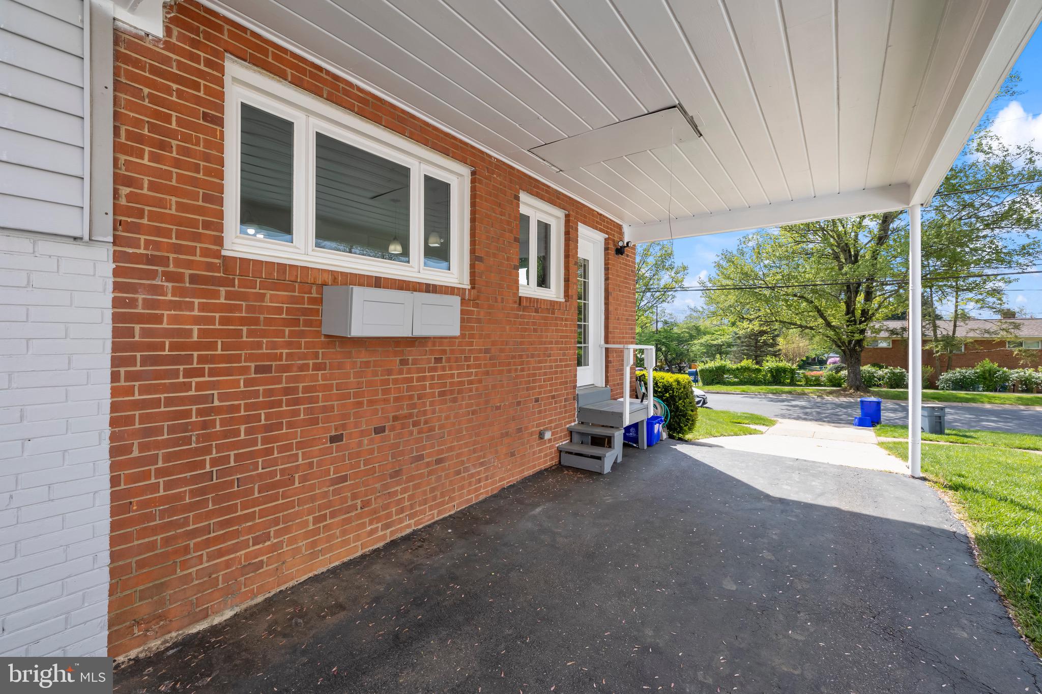 9821 Singleton Drive Bethesda, MD 20817 - Photo 41 of 45 a view of a house with backyard and a porch