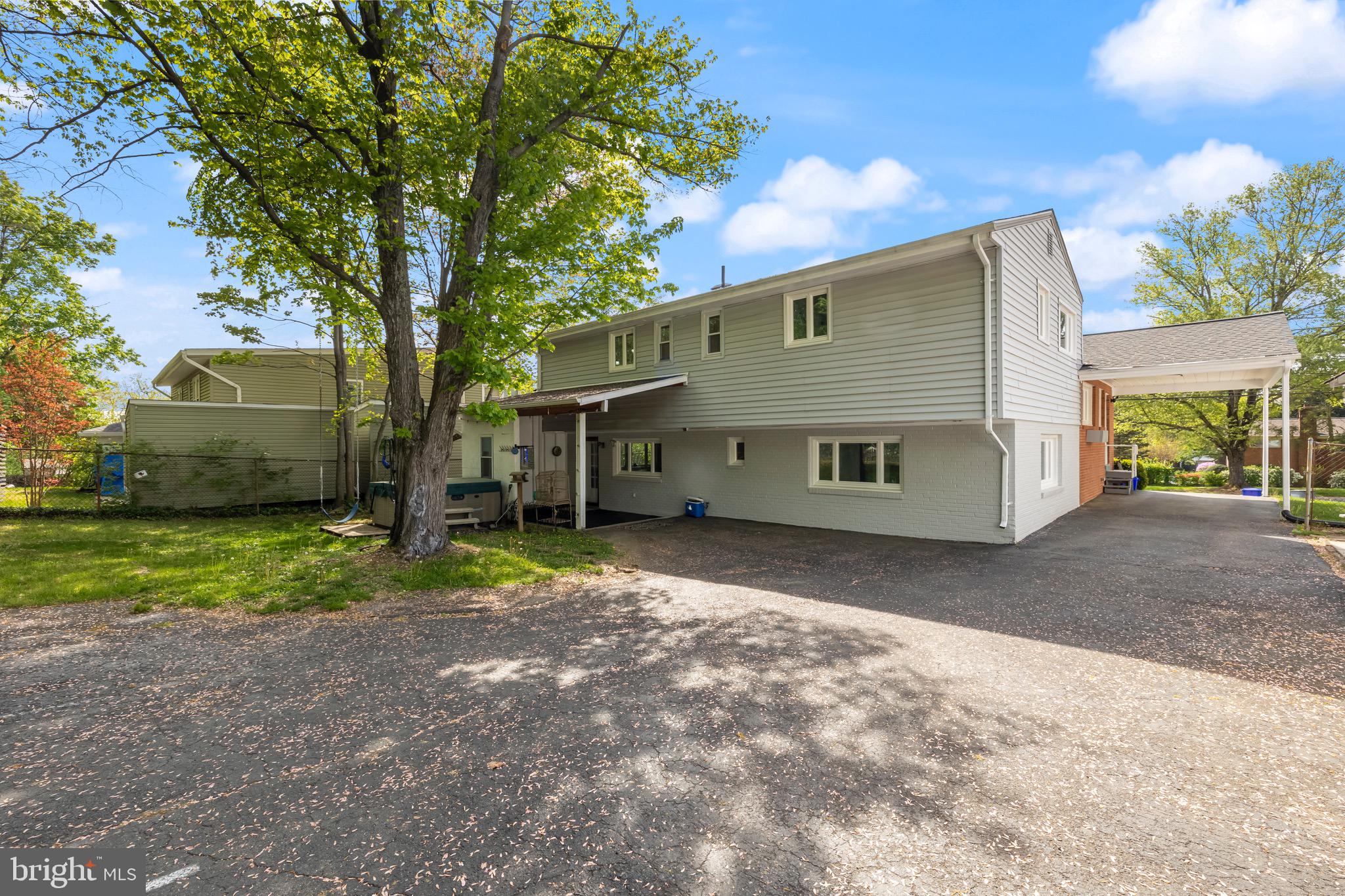 9821 Singleton Drive Bethesda, MD 20817 - Photo 44 of 45 a view of a house with a yard and large tree