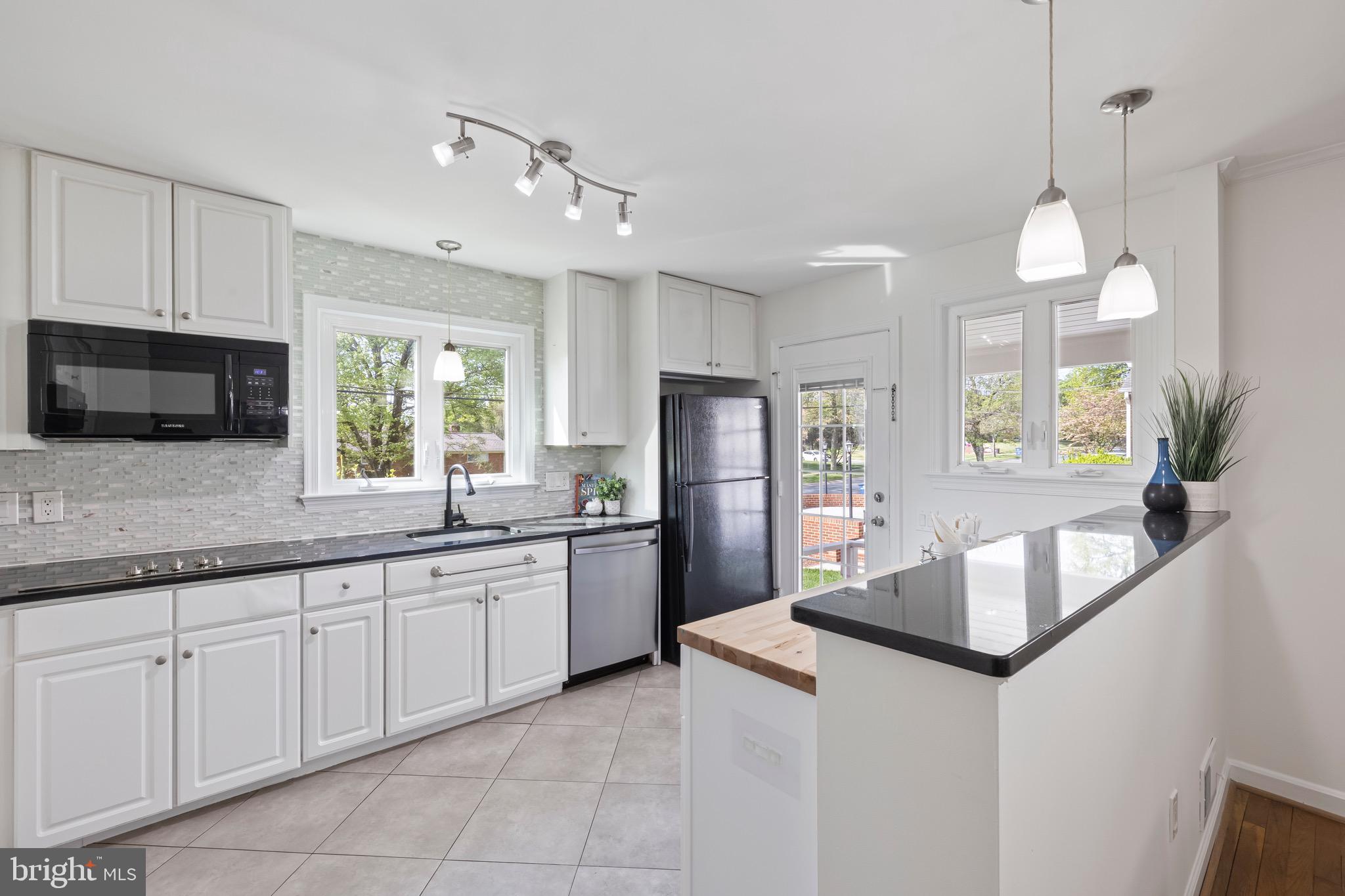 9821 Singleton Drive Bethesda, MD 20817 - Photo 8 of 45 a kitchen with stainless steel appliances granite countertop a sink refrigerator and microwave