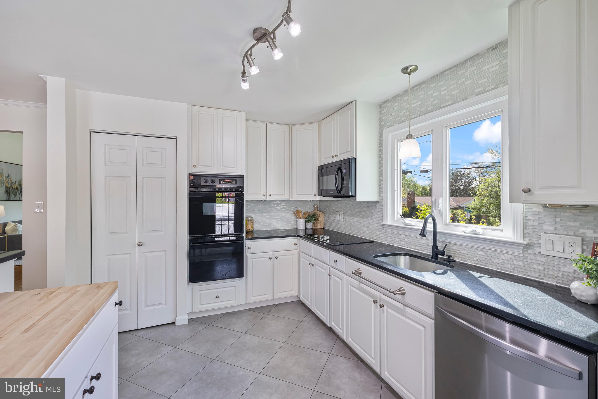 9821 Singleton Drive Bethesda, MD 20817 - Photo 10 of 45 a large kitchen with stainless steel appliances granite countertop a sink and cabinets
