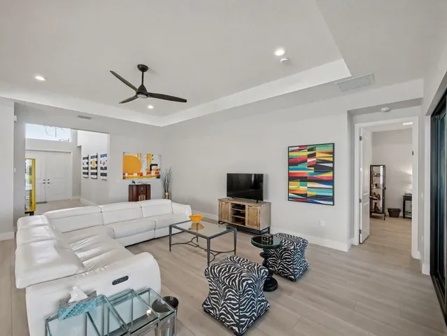 a living room with furniture and kitchen view