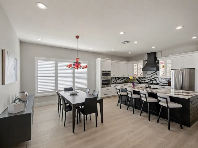 a view of a dining room with furniture wooden floor and a chandelier