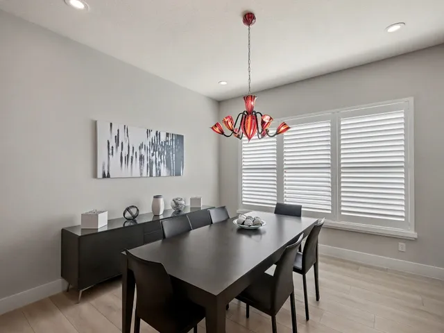 an aerial view of residential houses with outdoor space and seating