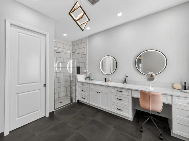 a bedroom with a bed a chandelier and a potted plant