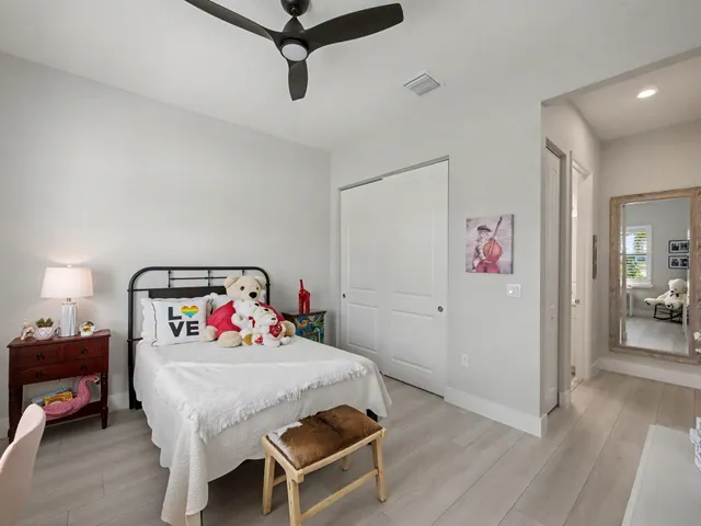 a bathroom with a sink a toilet a mirror and shower curtain