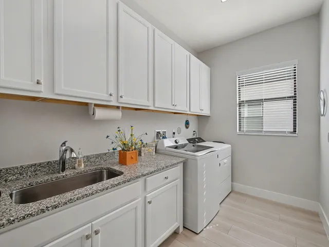 a work room with furniture and a floor to ceiling window