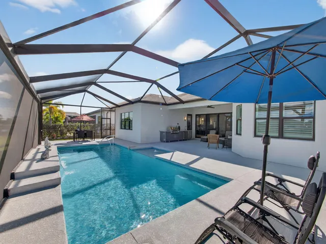 a view of a house with a big yard plants and large trees