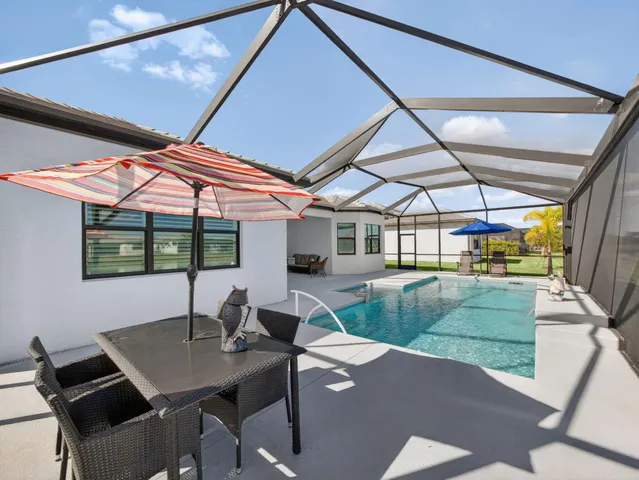 an aerial view of a house with a garden and a car parked