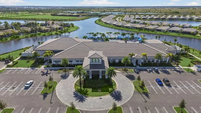 an aerial view of residential houses with outdoor space and swimming pool